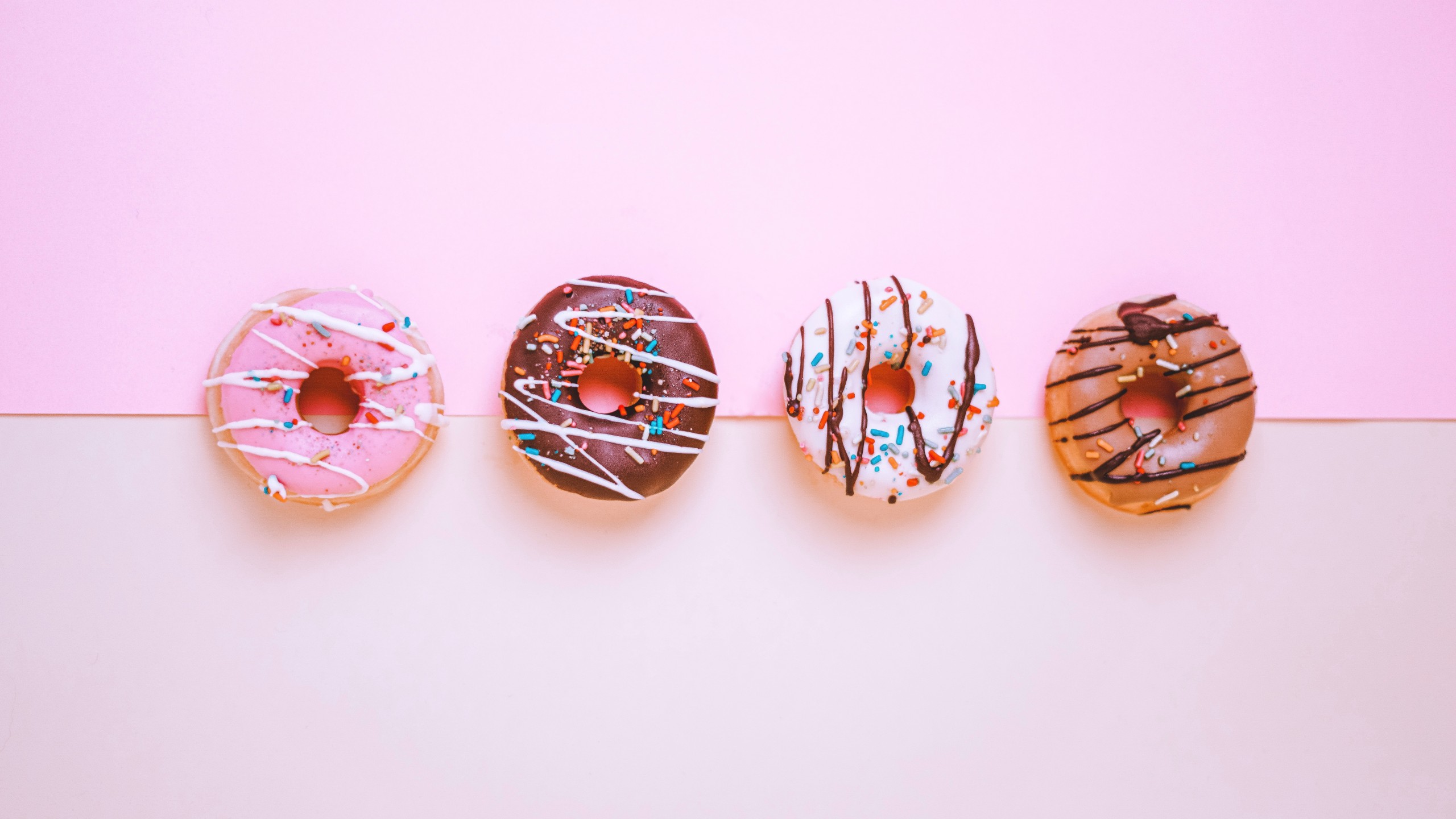 4 donuts pink background