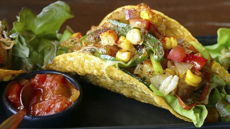 hard shell taco with corn and sauce