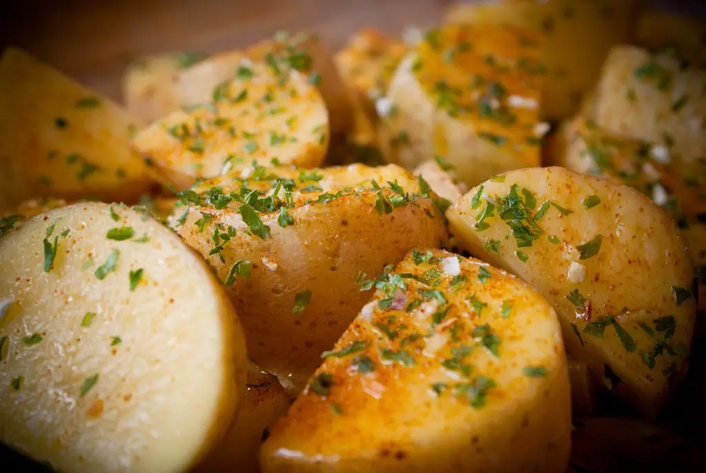 potatoes seasoned ready to be put in the oven
