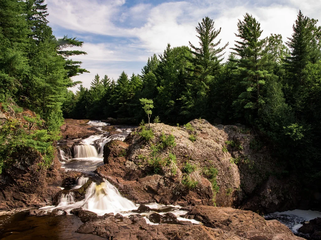 A winding series of cascades above the main attraction on the Potato River