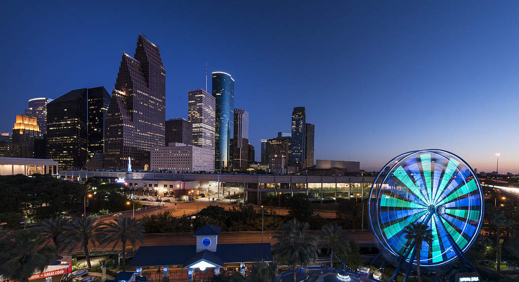 Dusk shot of Houston, taken from the Downtown Aquarium. The spinning wheel at the right is the aquarium's Ferris wheel