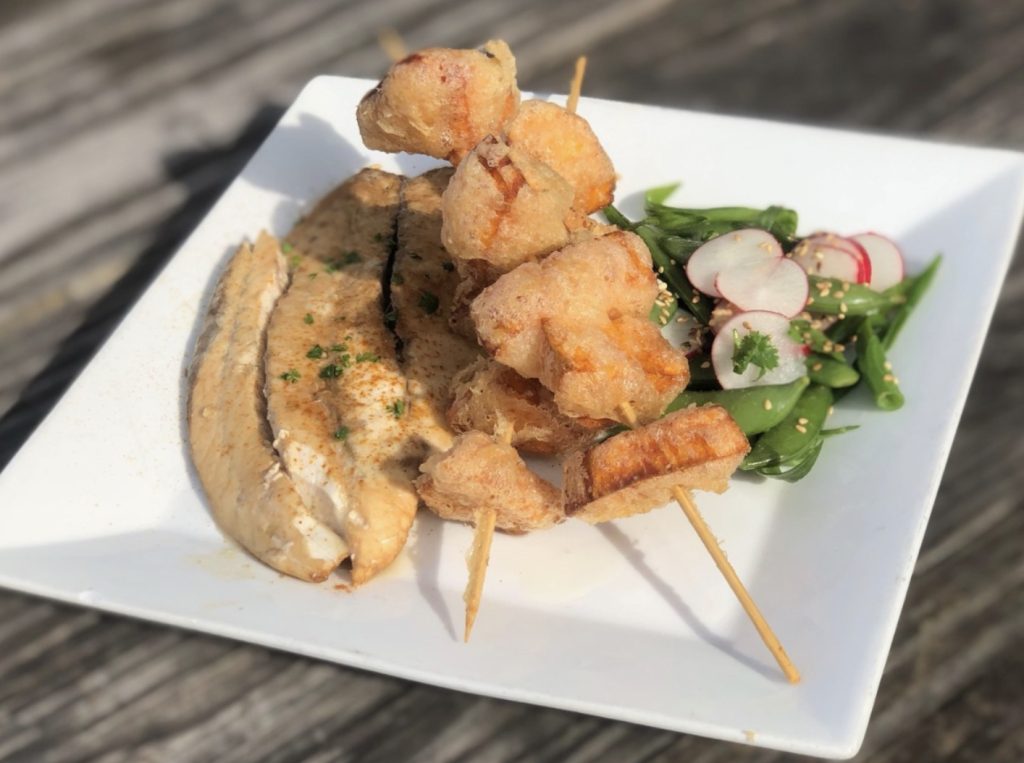 Ponzu & lemon grass marinated Barramundi fish fillet w/snap pea, scallion & radish salad, toasted sesame seeds, sweet potato tempura skewer.