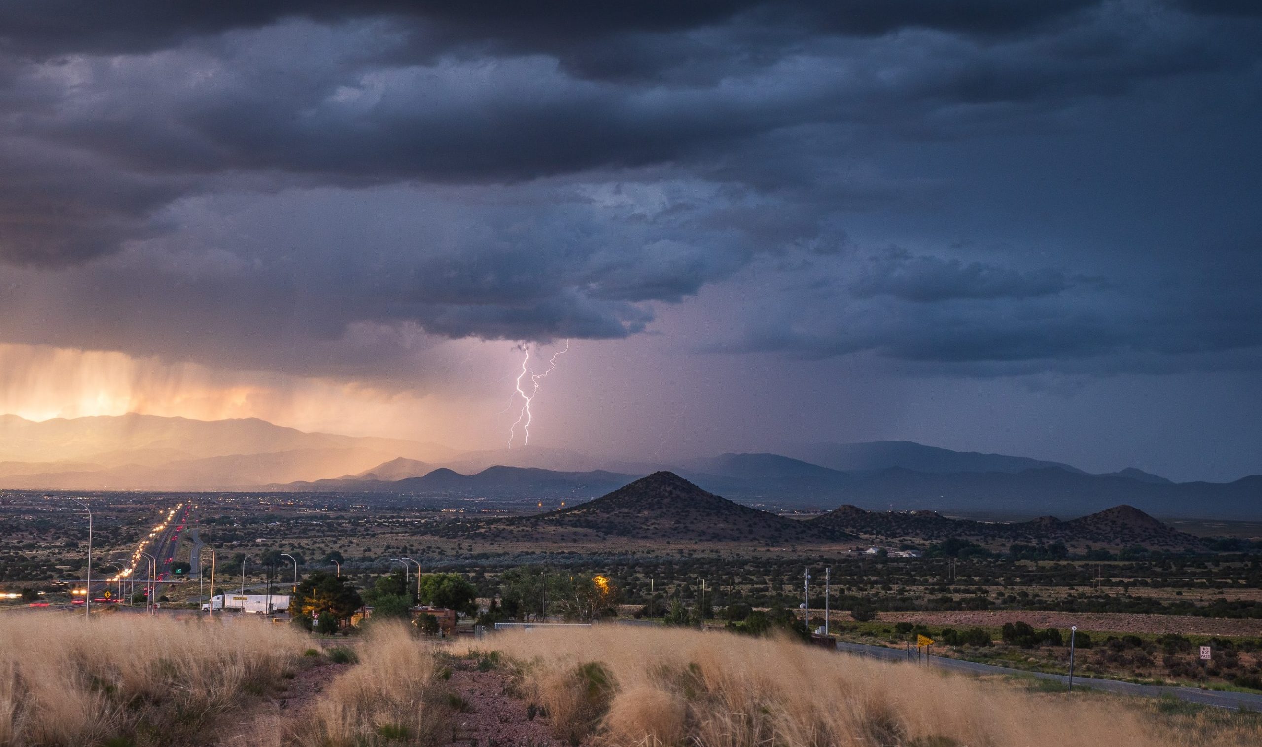 Lightning striking the Santa Fe mountains during monsoon season in New Mexico.