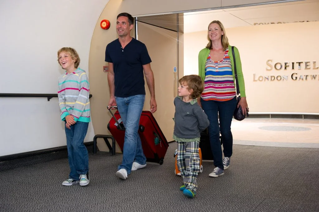 family walking out hotel 