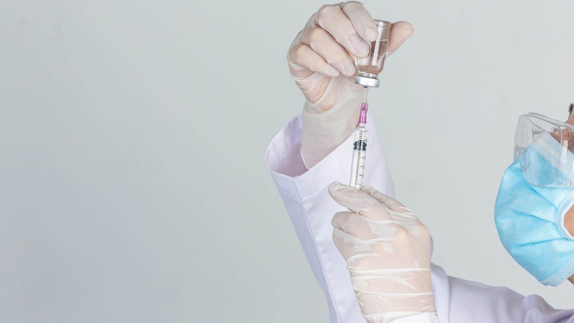 Doctor drawing insulin syringe