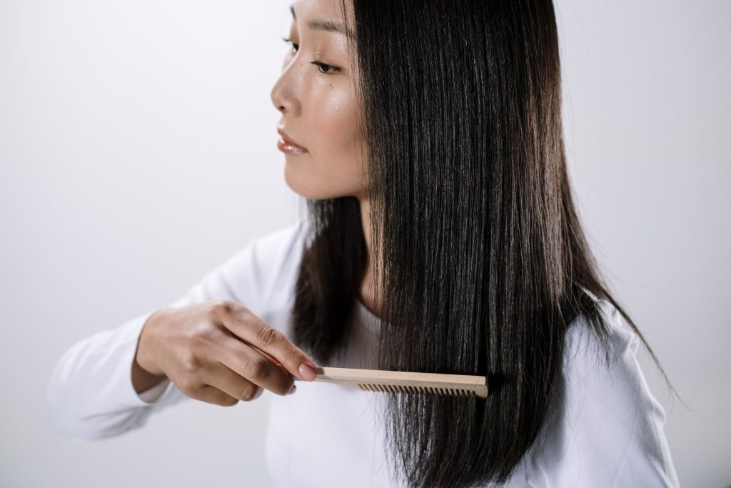 women combing her black hair