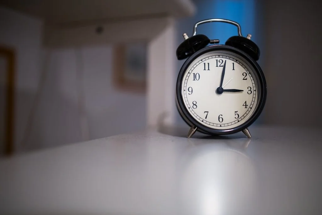 black and white clock on a white table