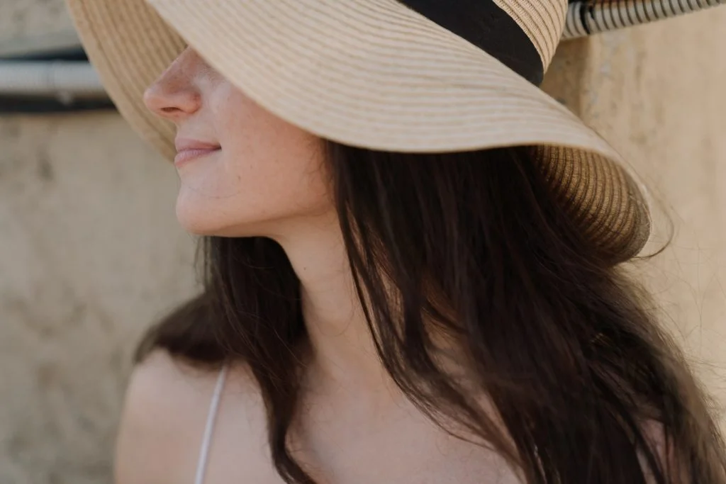 women weaing a hat in sun