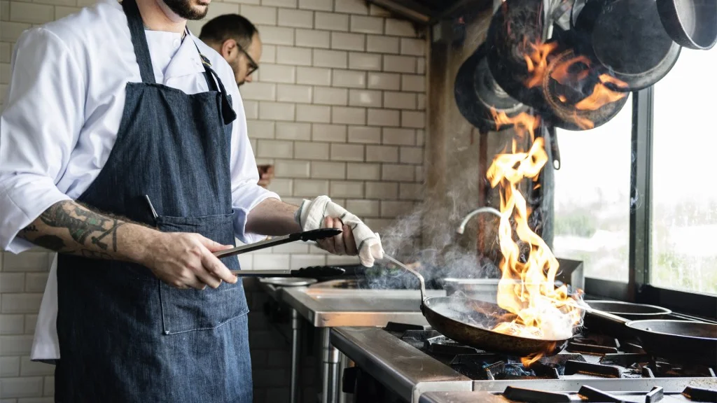 Chef cooking food in a restaurant kitchen