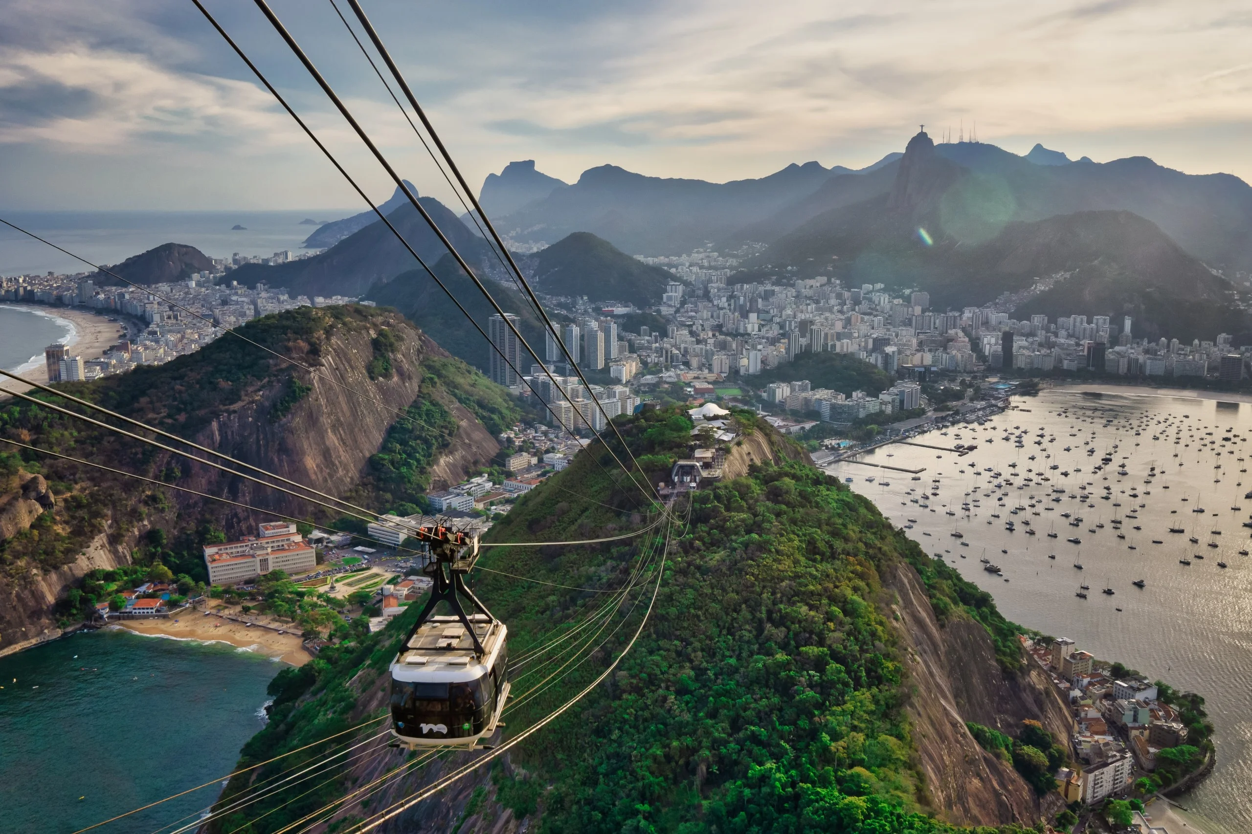 View from a cable car over Copacabana and downtown Rio de Janiero from sugar loaf mountain at golden hour.