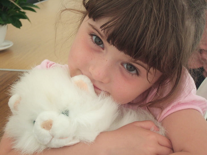 Kid playing with stuffed toy